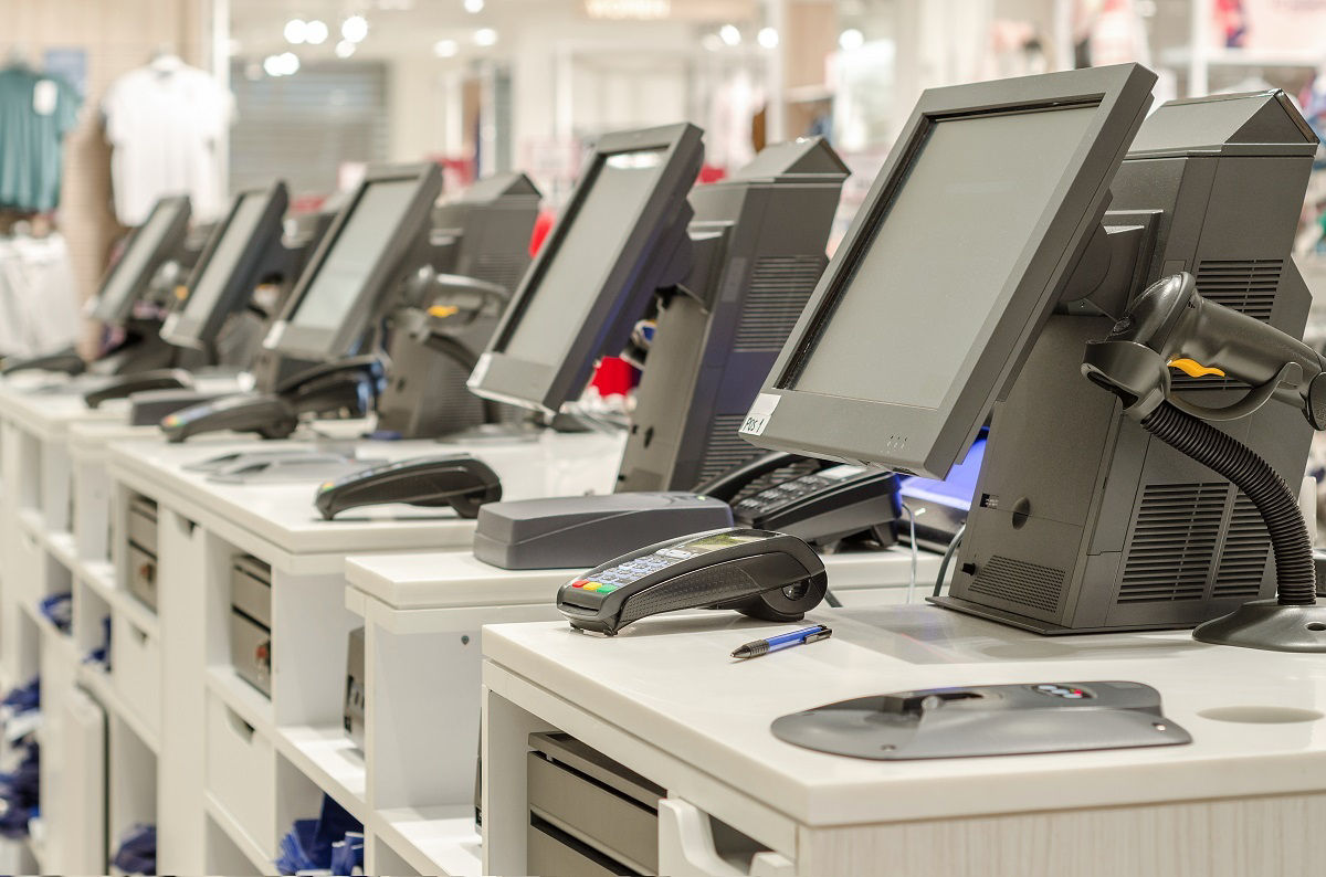 Several POS devices standing in a row in a store