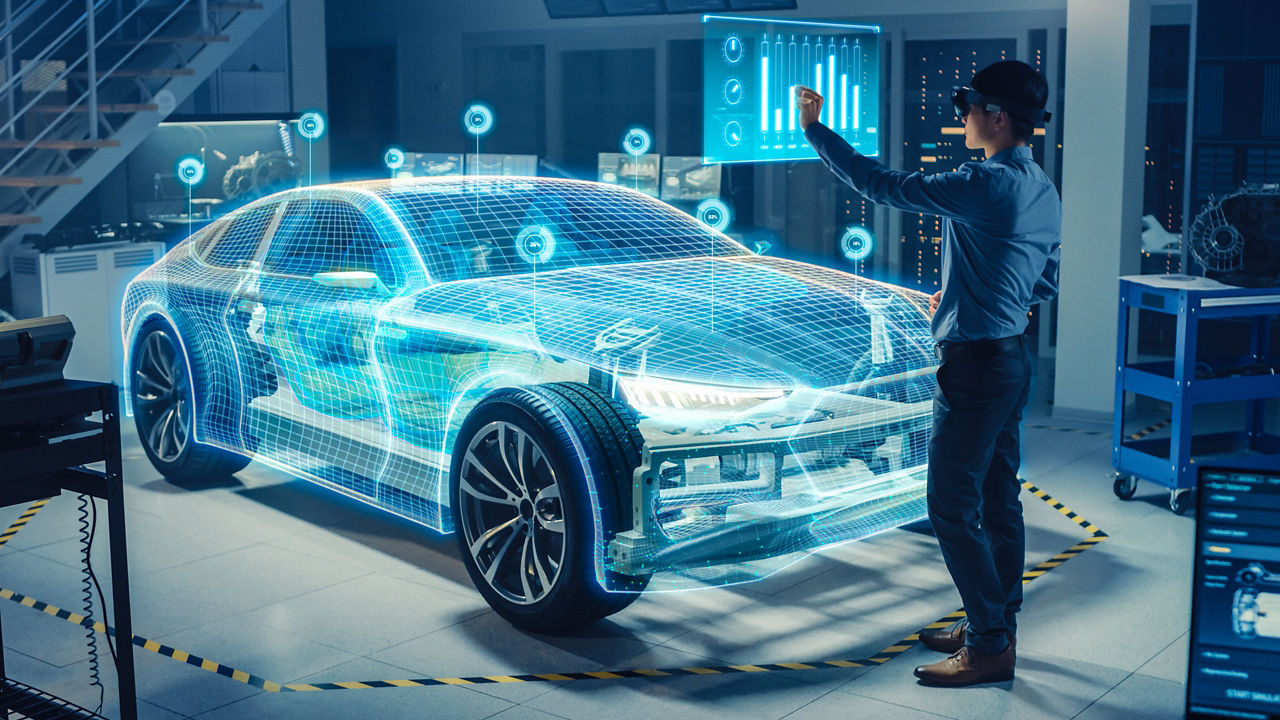 仮想現実ヘッドセットを使用してバーチャルな電気自動車の 3D モデルを分析している車両設計エンジニア