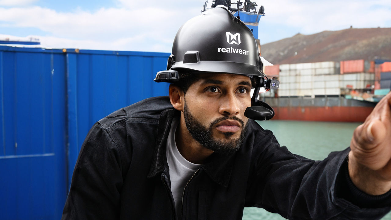 Close-up of man with safety helmet and smart glasses