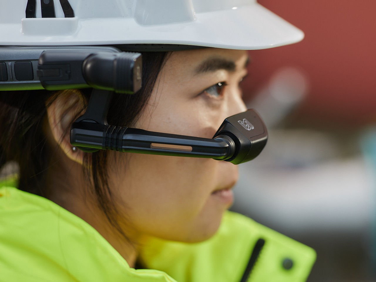 Close-up of woman with safety helmet and smart glasses