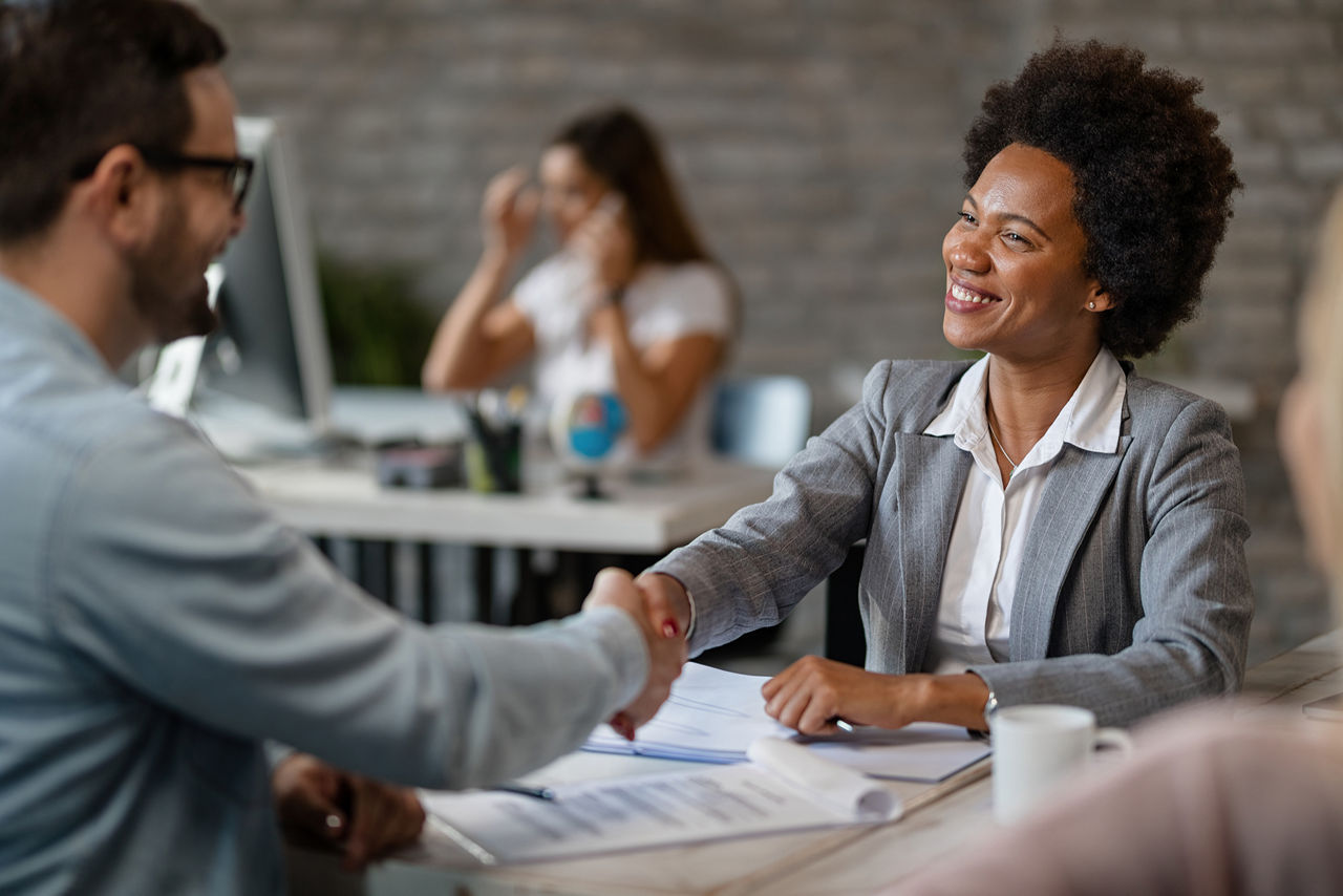 Bank manager shaking hands with a client after successful agreement