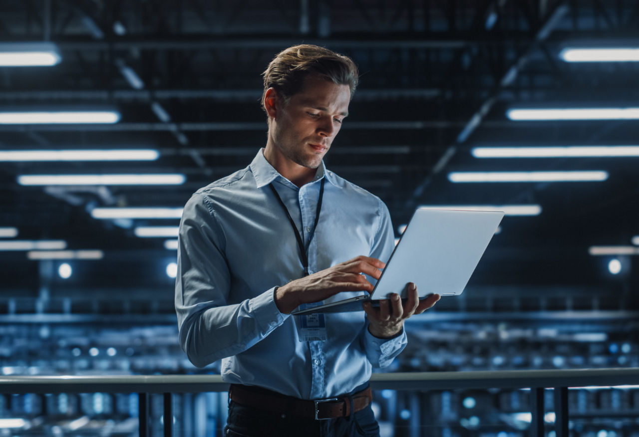 Man and woman discussing plans holding a laptop