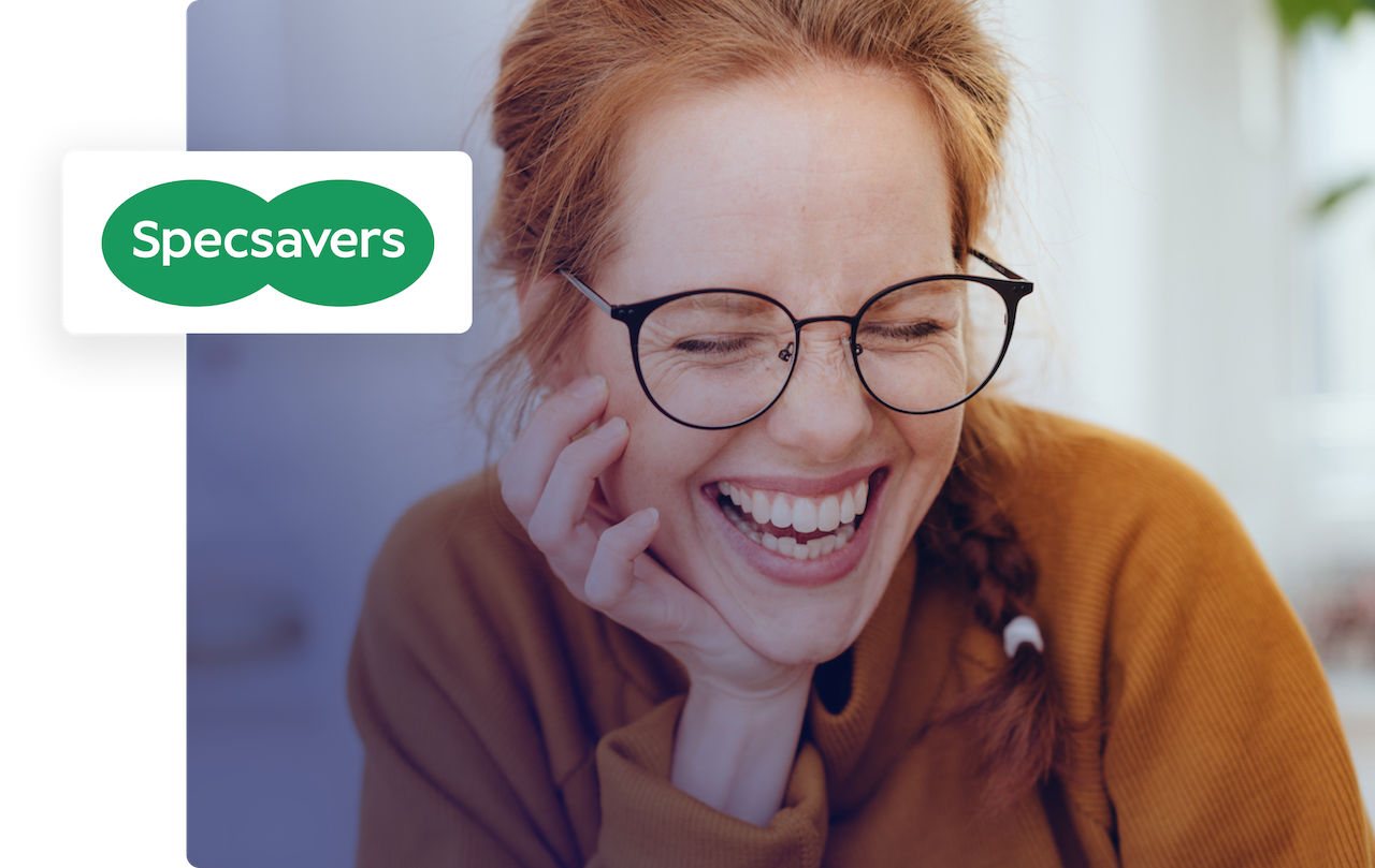 Woman with glasses laughing happily