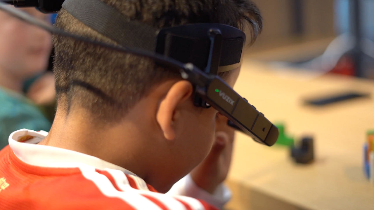 Child using smart glasses to solve puzzle