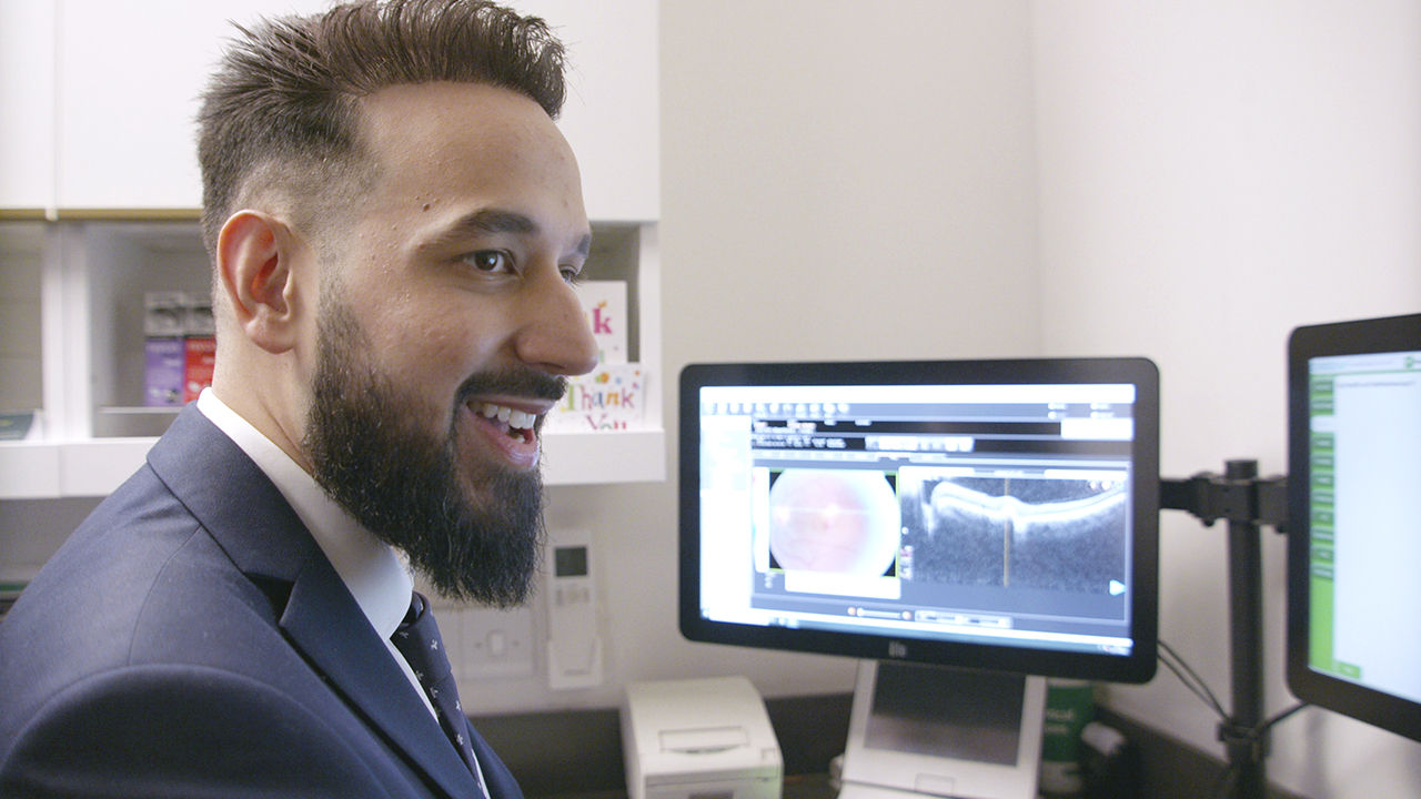 Store employee administrating eye exam