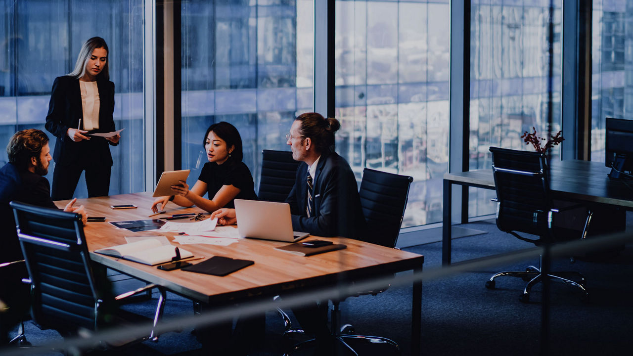 Group of colleagues working together in a modern meeting room