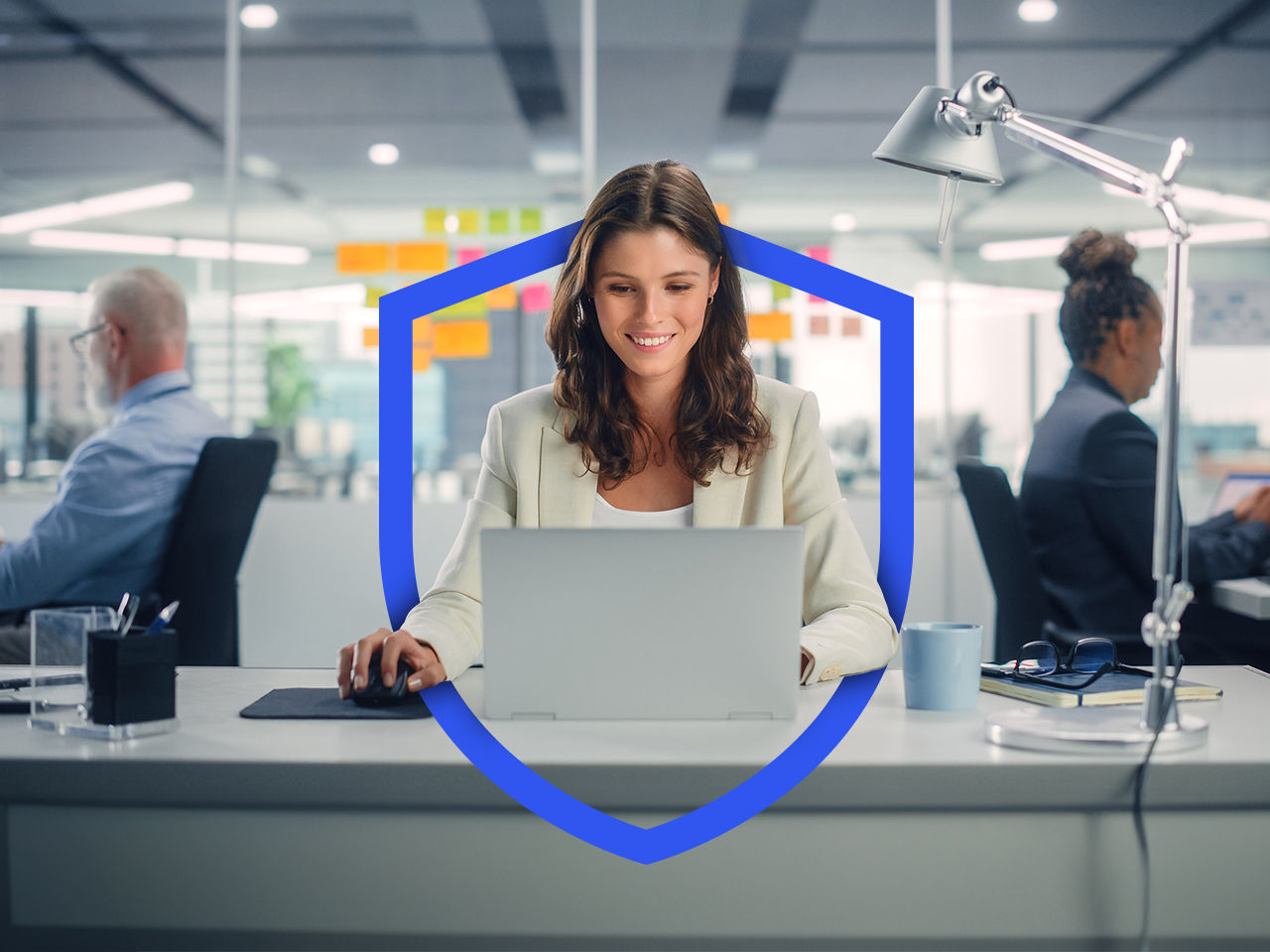 Women working at desk with colleagues