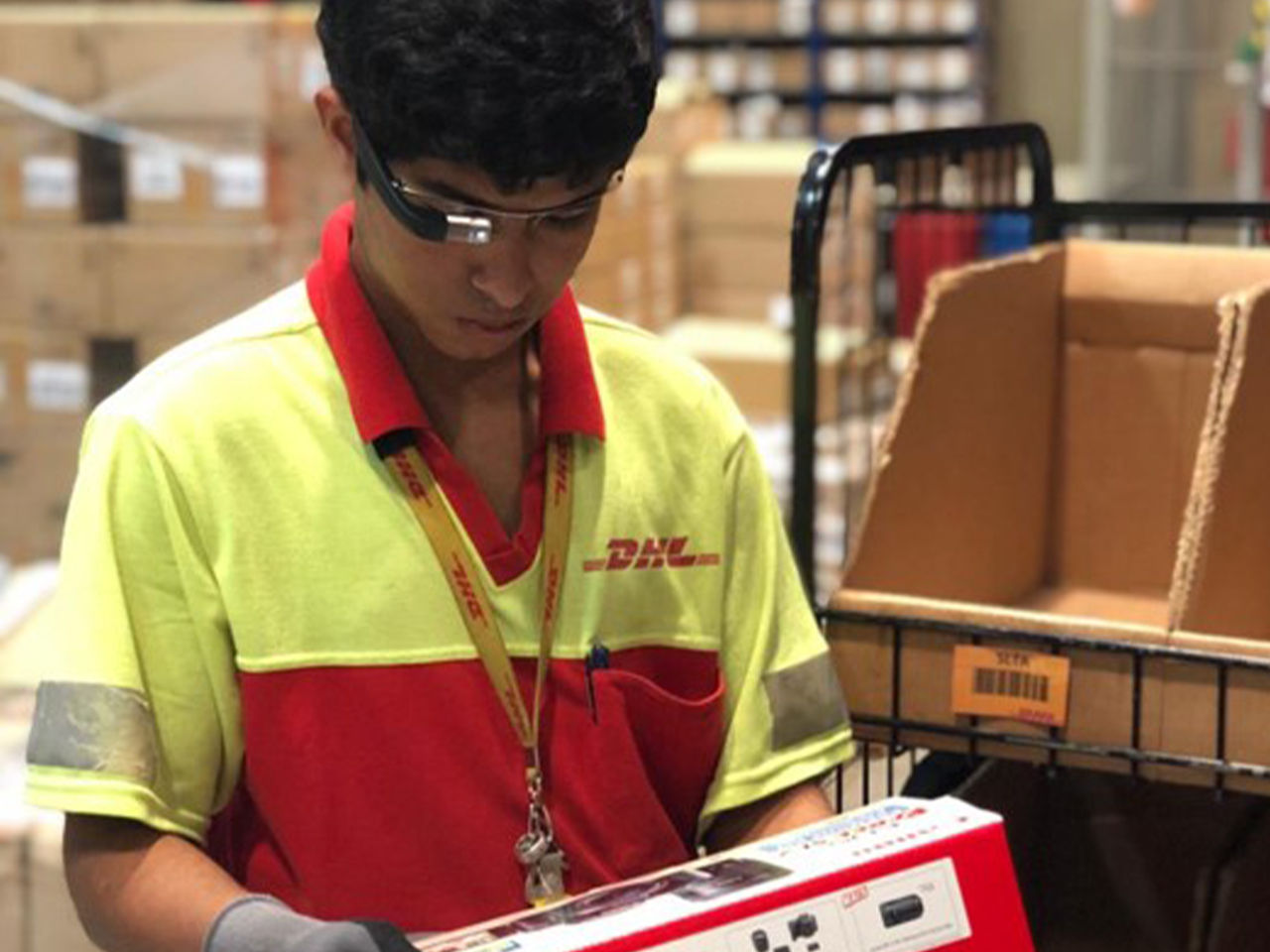 DHL employee with smartglasses in warehouse
