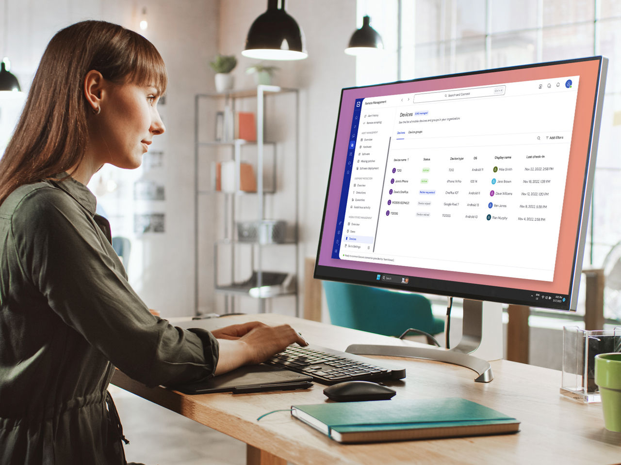 Woman using TeamViewer Mobile Device Management on computer