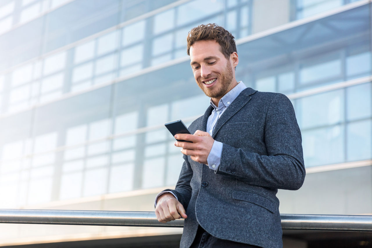 Businessman holding smartphone for business work