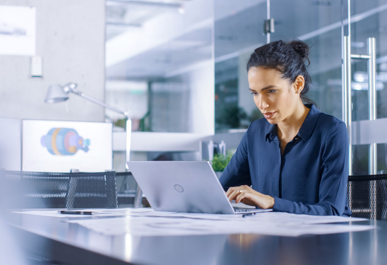 Woman working on laptop in modern office