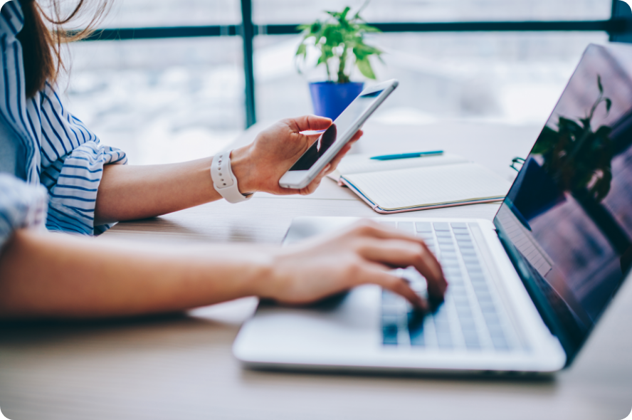 Woman using laptop and smartphone