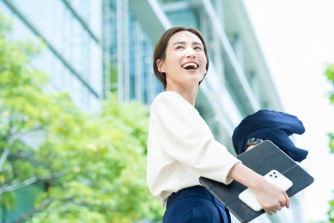 Woman outside with mobile phone and tablet