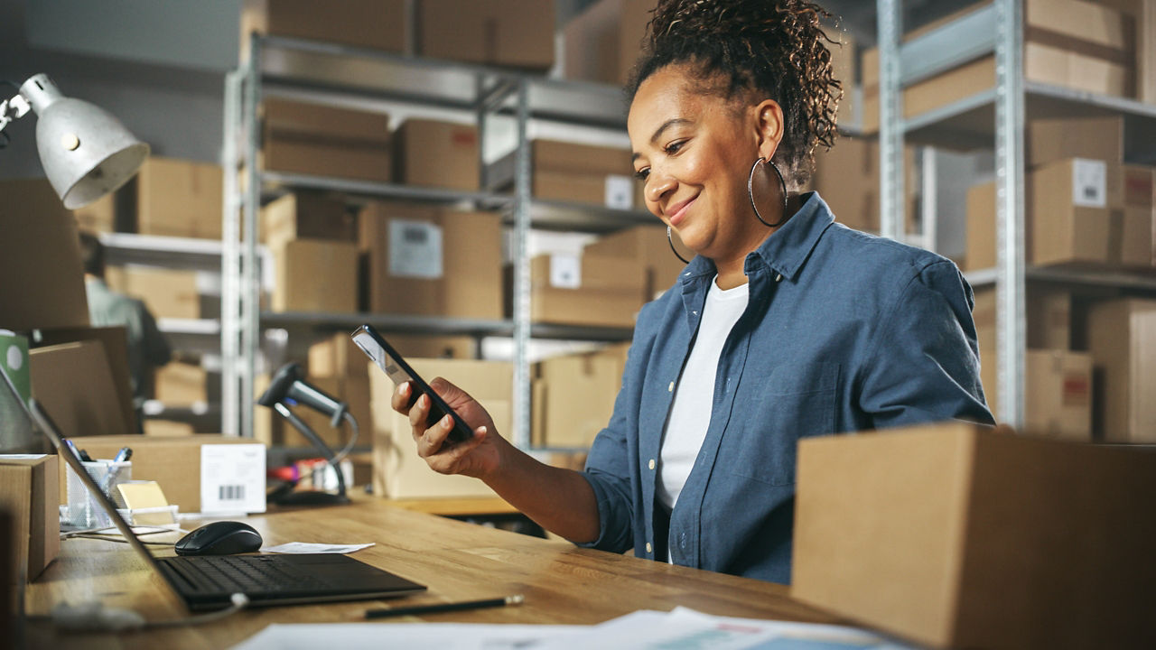 Inventory manager using smartphone to scan a barcode on parcel