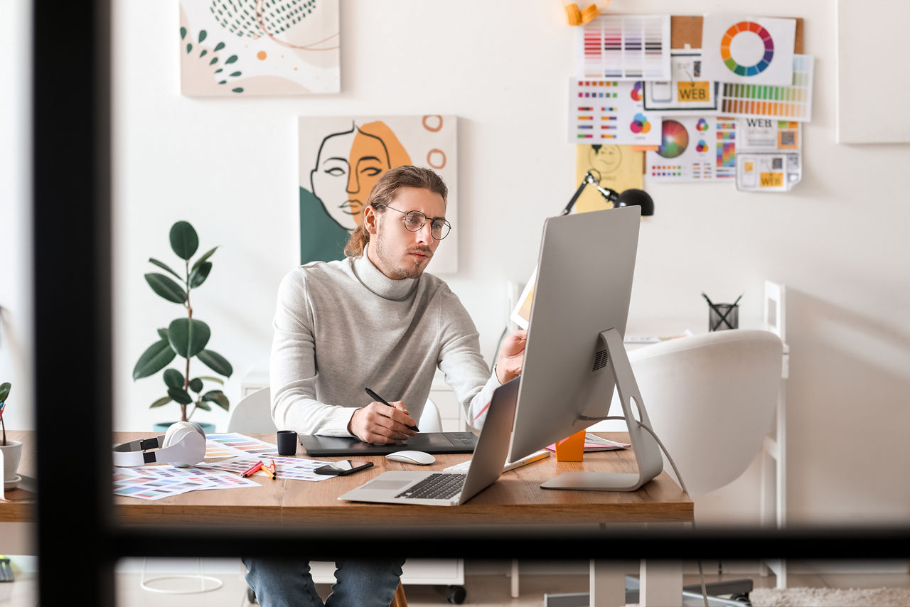 Young male designer working in office