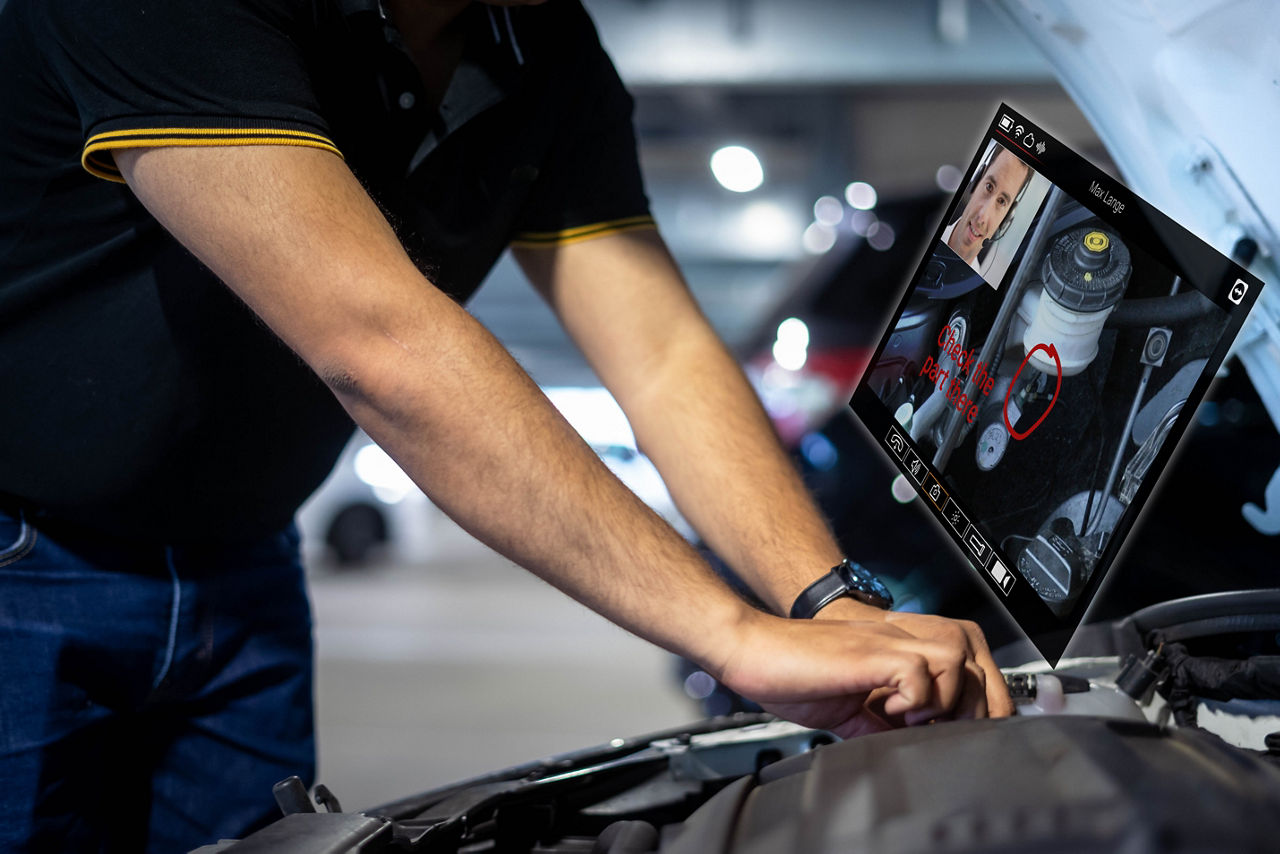 Worker using TeamViewer Frontline to resolve automotive issues