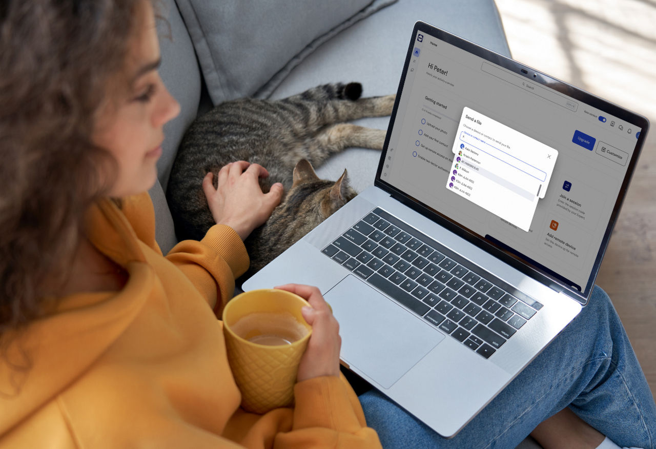 A woman transferring files from her laptop using her contact lists